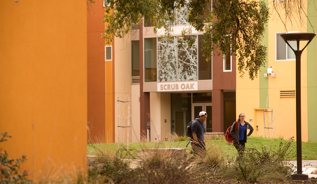 Two Students walking near a UC Davis residence hall