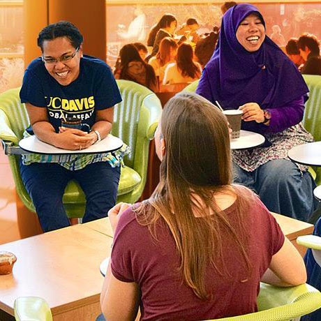 "Students laughing in a study space on campus"