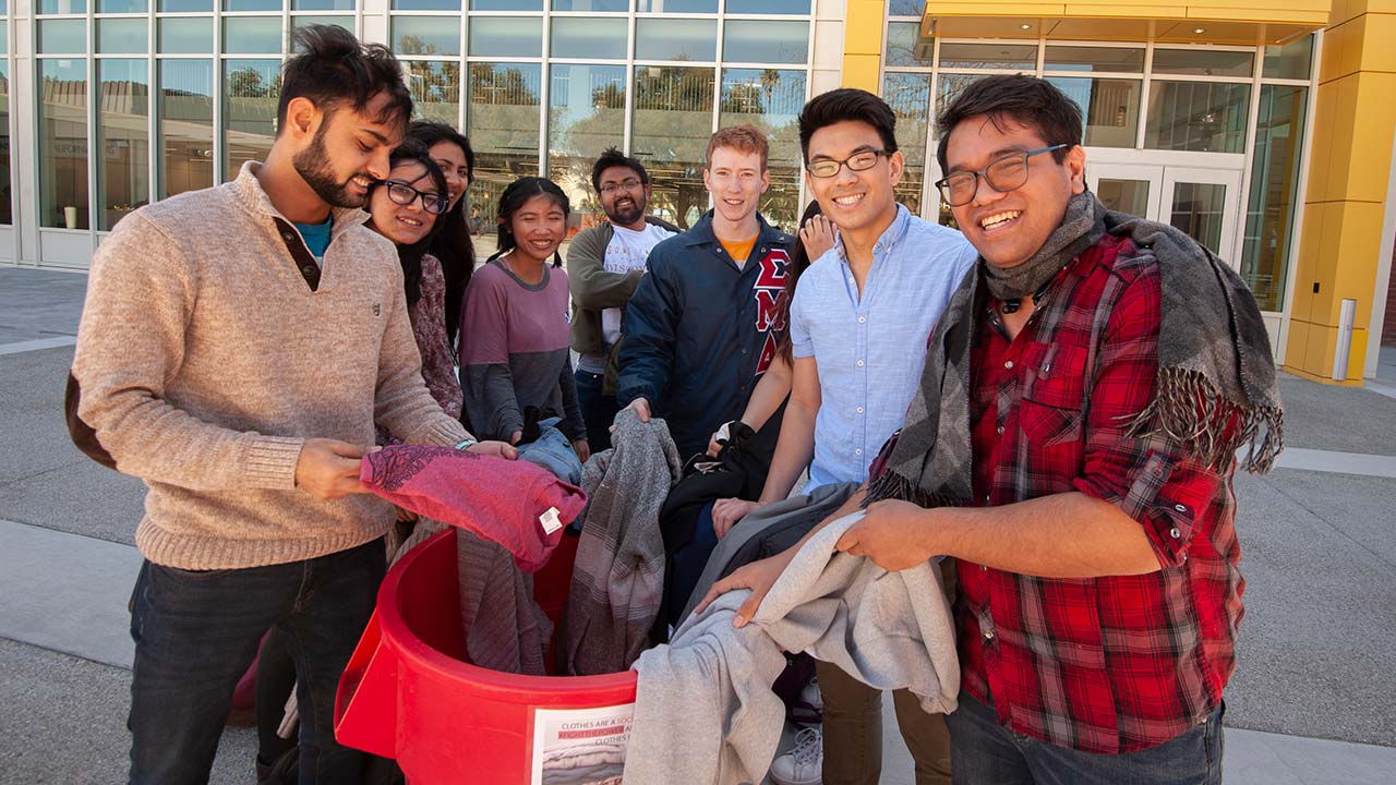 Seniors and Best friends Awais Khan and Chun Kit Ho with other Homies looks through donated clothes on March 15, 2019. 
