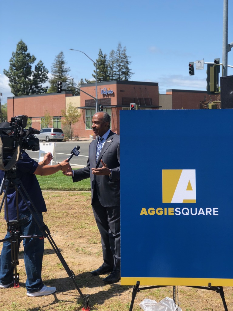 Mayor Steinberg by Aggie Square sign