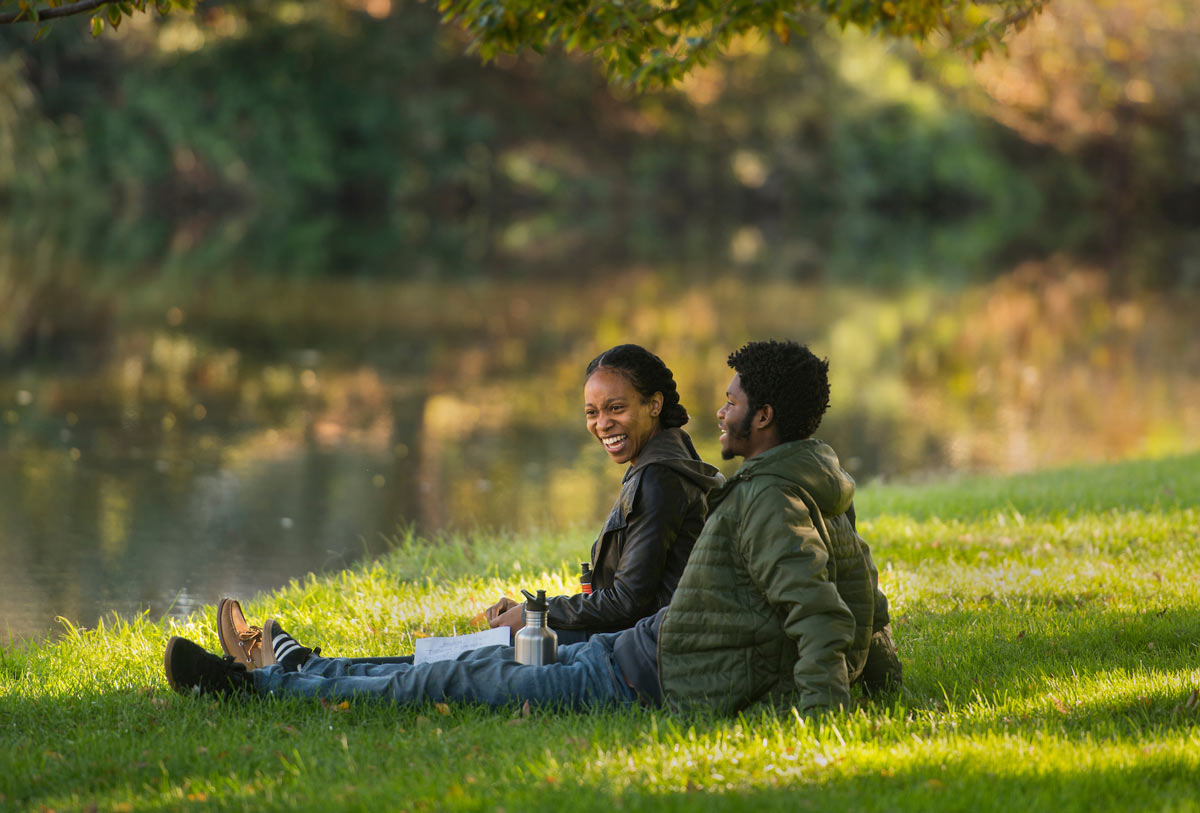 two students laughing in the arboretum