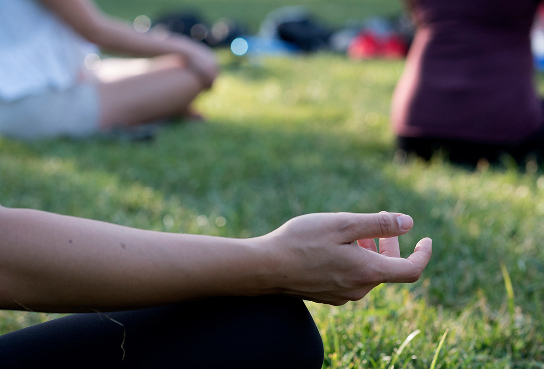 A student meditates on the UC Davis Quad