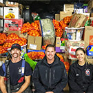 Firefighters sit in front of donated goods.