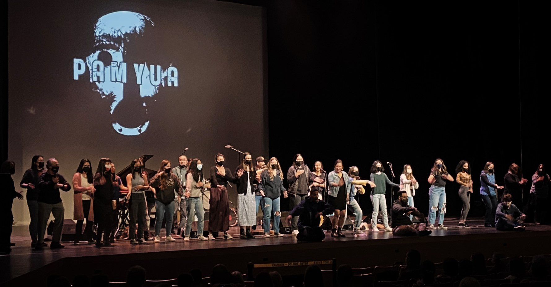 A group of people on a darkened stage at the Mondavi Center