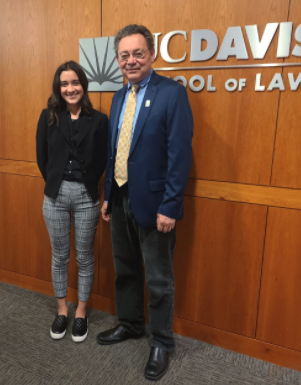 two people stand in front of UC Davis School of Law sign