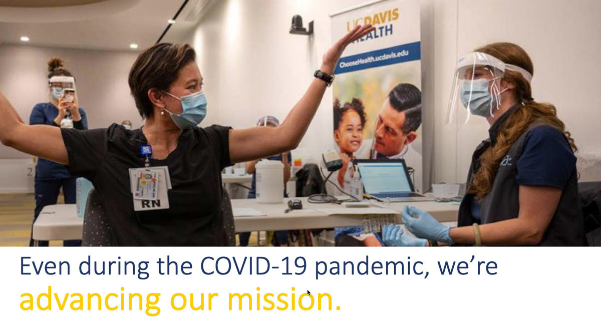 PowerPoint slide: Female nurse holds arms up in joy after receiving COVID-19 vaccine.