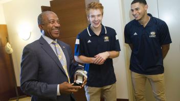 UC Davis men’s basketball players Siler Schneider, Roger Printup and Chima Moneke (not pictured) and coach Jim Les (not pictured) visit Chancellor Gary May to give him his own Championship Basketball ring. The foursome visited the 5th floor of Mrak Hall on August 8, 2017.