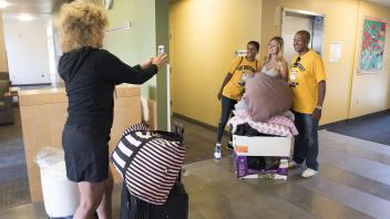 Laurie Meyers takes a photo of her daughter, Lainey Hauschildt, with LeShelle and Gary May as they help her move into her room in the Tercero Residence Halls on Saturday, September 23, 2017. Hauschhidlt is a freshman from Sebastopol, CA.