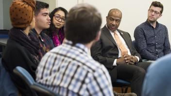 Chancellor Gary May listens to a group of students at the Transformative Justice Center