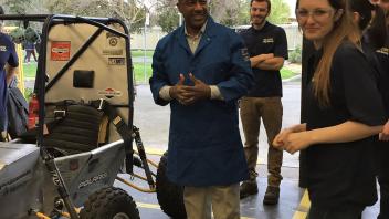 Chancellor May visits the College of Engineering Aggie Baja lab and prepares to take the student designed racecar for a ride. 
