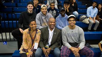 Chancellor May and his wife LeShelle May cheer on the women’s basketball team with a group of student athletes. 