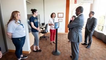 Chancellor May visits with staff at the Student Health and Wellness Center. 