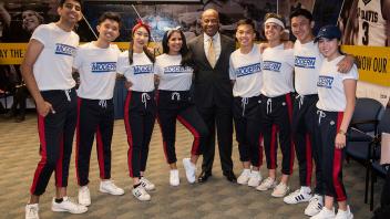 UC Davis Chancellor Gary May poses for a photo with the MK Modern dance group before the start or their performance at the Fall Welcome Event.