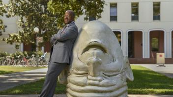 UC Davis Chancellor Gary May next to an egghead outside of Mrak Hall