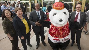 UC Davis Provost Ralph J. Hexter celebrates international cuisine with an Asian Panda mascot