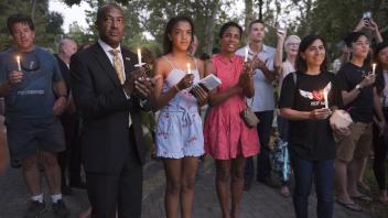 UC Davis Chancellor Gary May, his daughter Simone, and wife LeShelle stand with a group outside