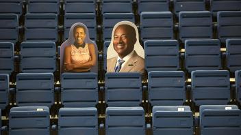 Cardboard cutouts of Chancellor Gary May and LeShelle May are perched in chairs at The Pavilion.