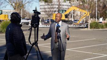 Photo of Chancellor Gary May doing a video interview for the Sacramento Bee with construction behind him