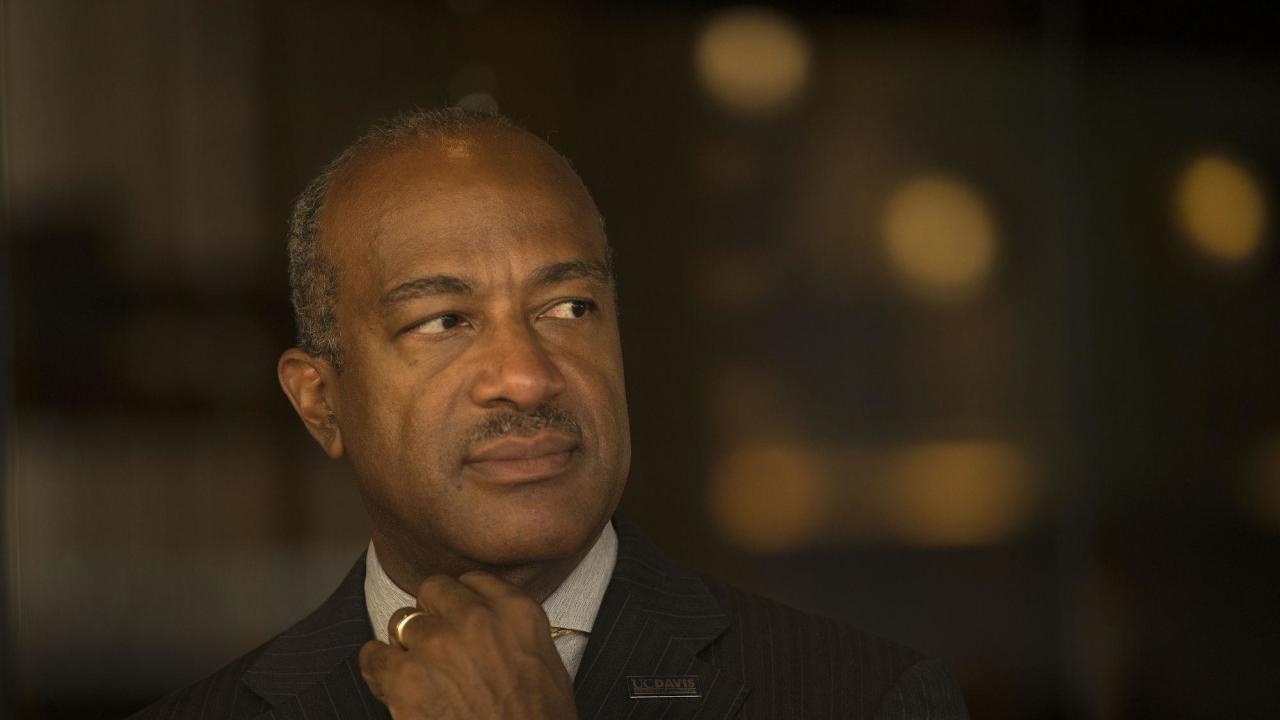 Chancellor Gary May seriously and thoughtfully looking to the side
