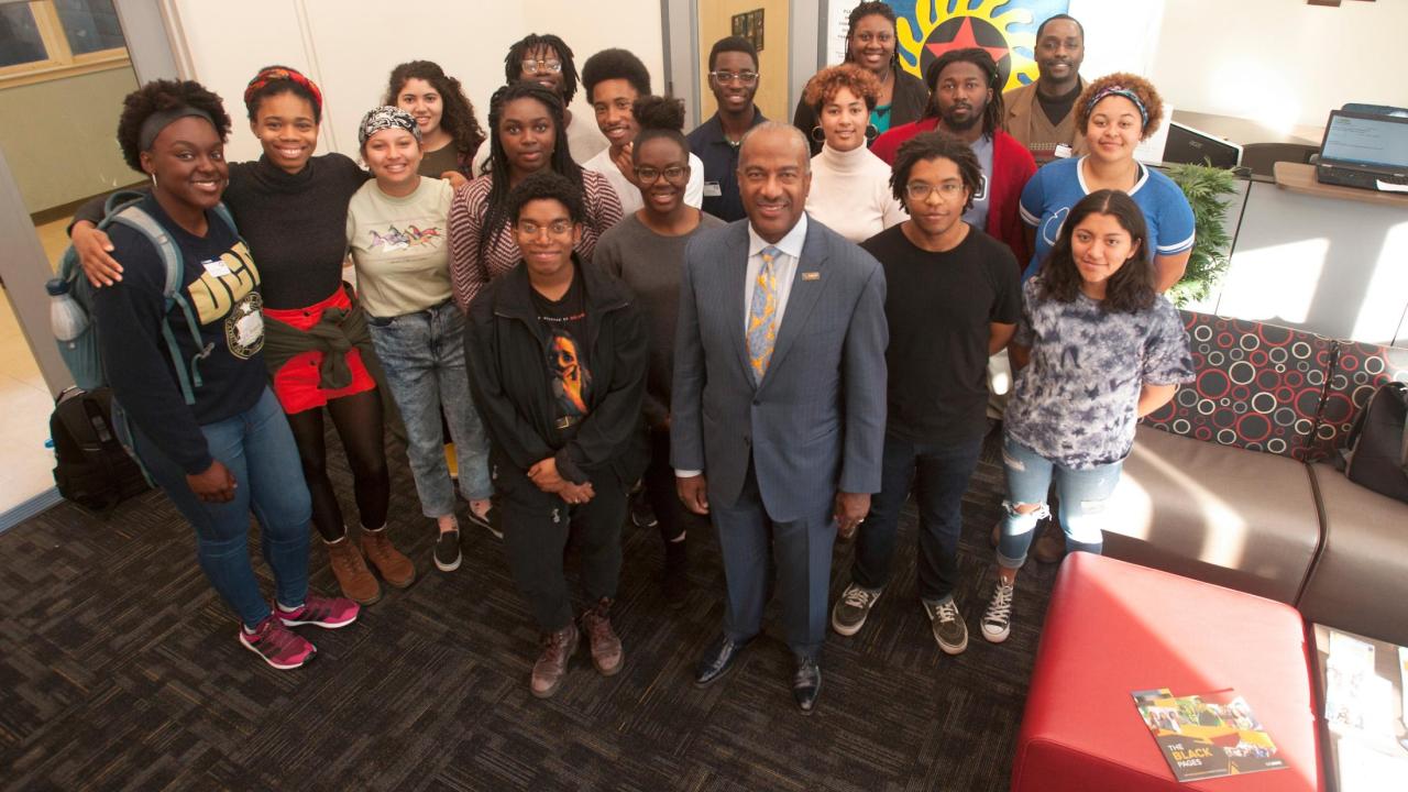 Chancellor Gary May visits with students at the Center of African Diaspora Student Success. Chancellor Gary May stands with students at the Center of African Diaspora Student Success