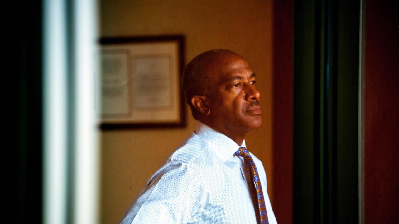 Chancellor May looking out a window thoughtfully