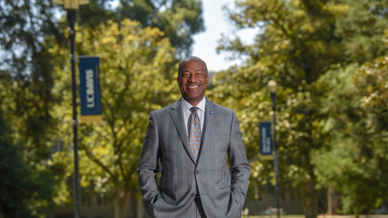 Chancellor May outdoors looking into the camera standing on the quad