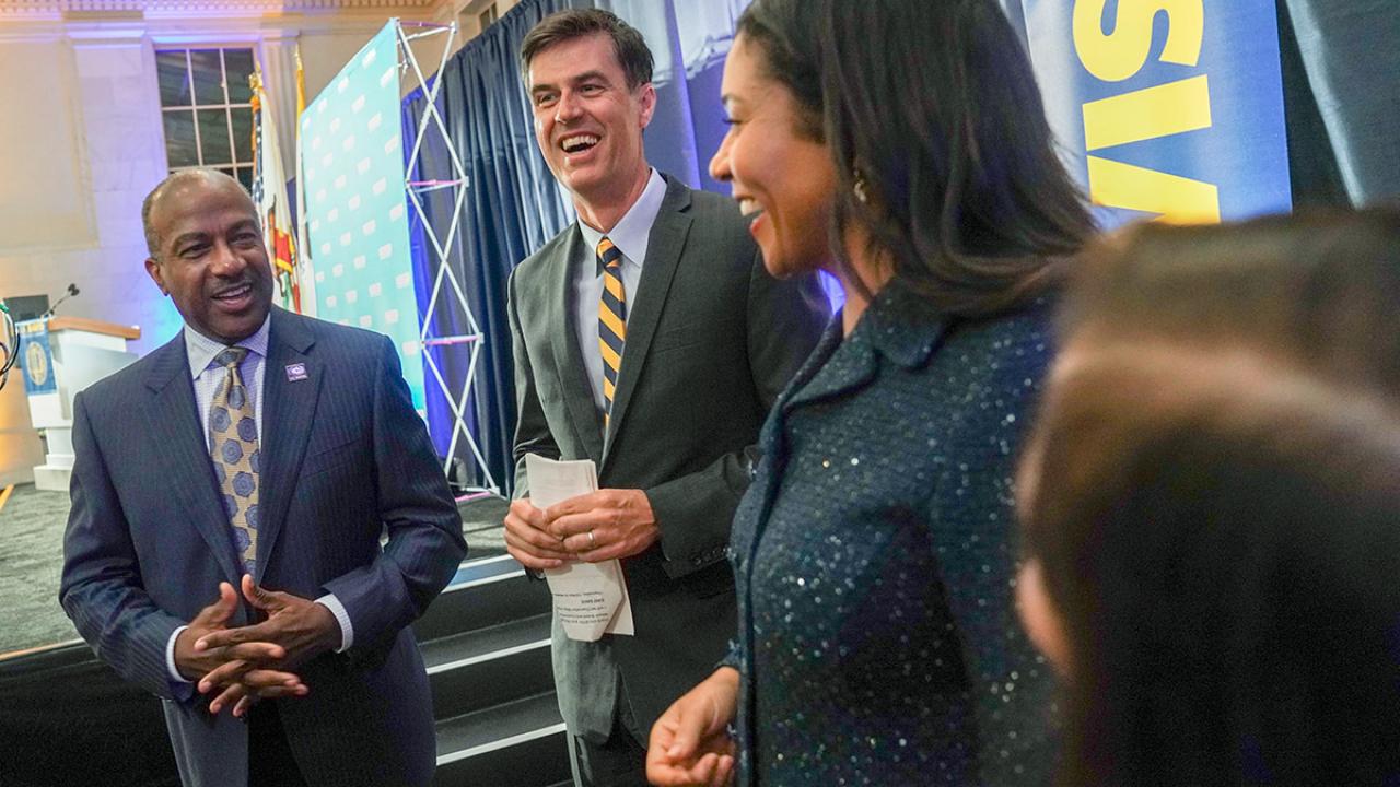 Chancellor Gary S. May standing next to journalist Dan Brown ’92 and San Francisco Mayor London Breed ’97 in August.