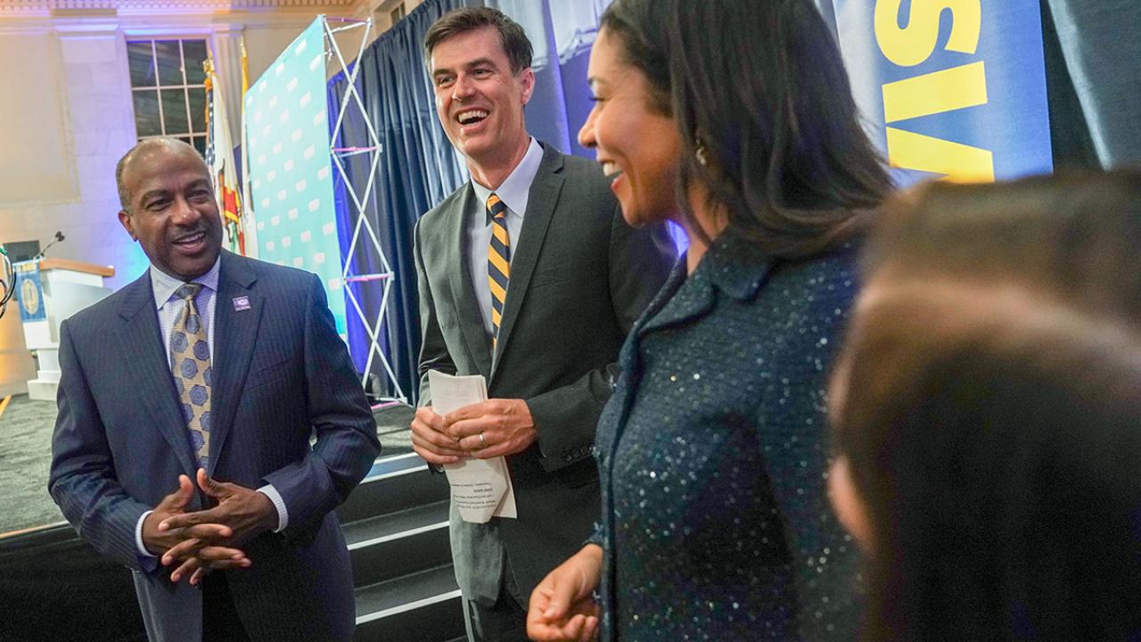 Chancellor Gary S. May with journalist Dan Brown ’92 and San Francisco Mayor London Breed ’97 in August. Chancellor Gary S. May standing next to journalist Dan Brown ’92 and San Francisco Mayor London Breed ’97 in August.