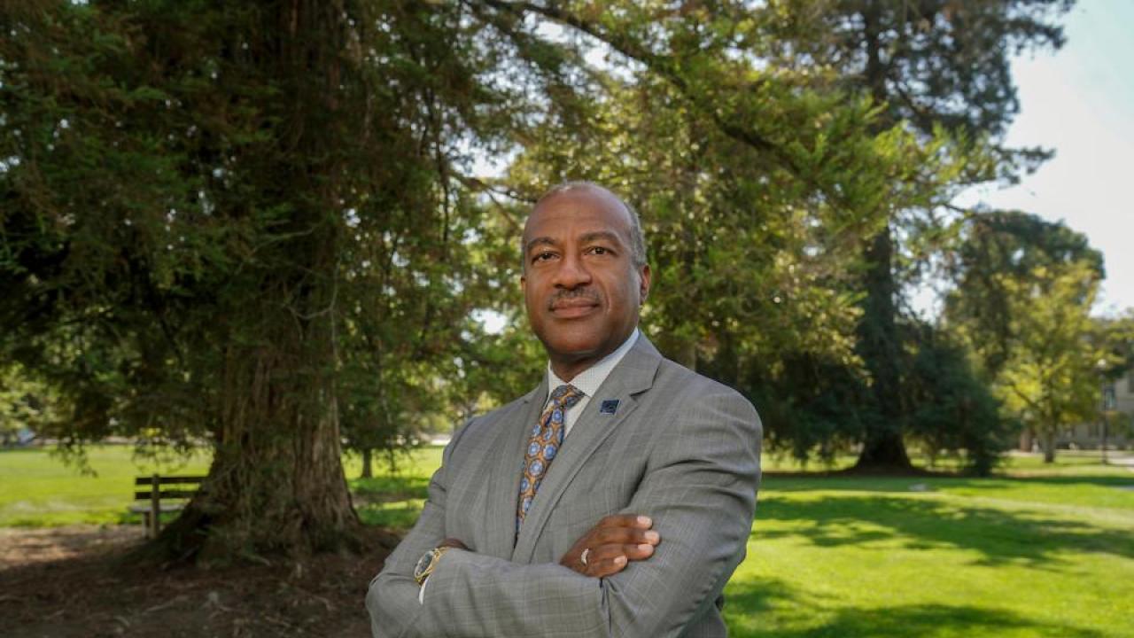 Chancellor May with arms crossed outside looking at the camera.