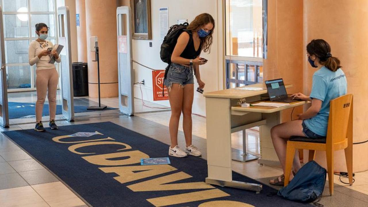Students entering Shields Library on the first day of instruction must show their daily symptom surveys and scan their ID cards.