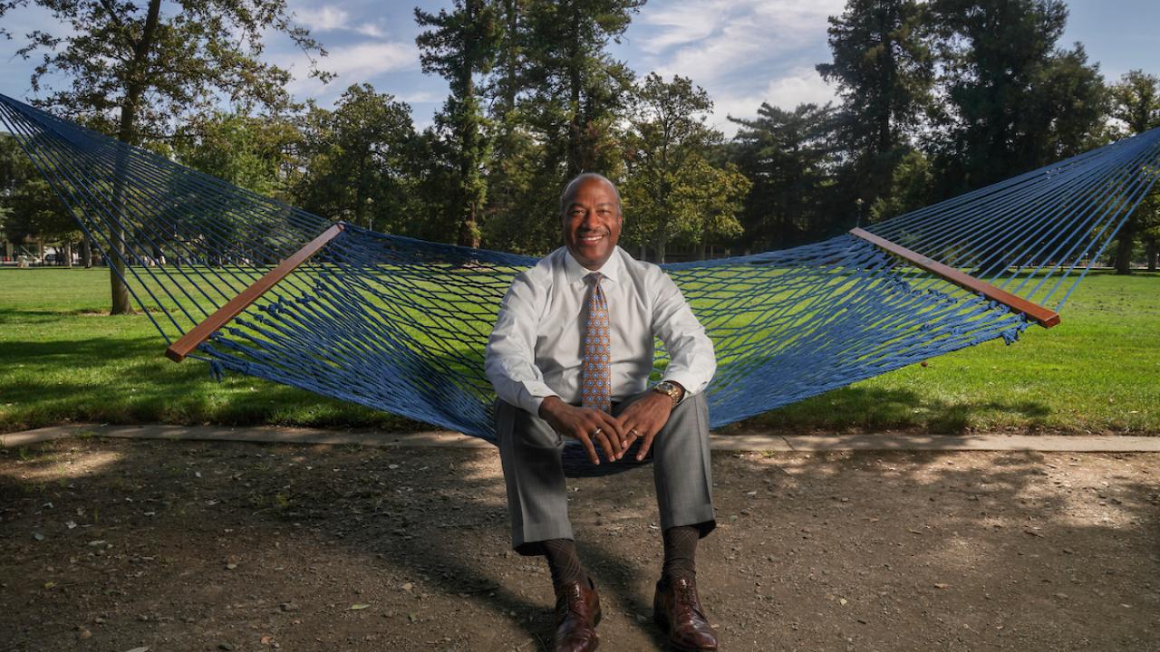 Chancellor May sitting in a hammock on the quad.