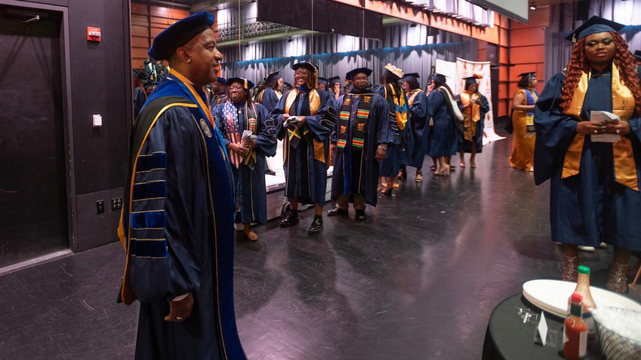 Chancellor May standing with students and faculty at Black Graduation Ceremony on Jun 17