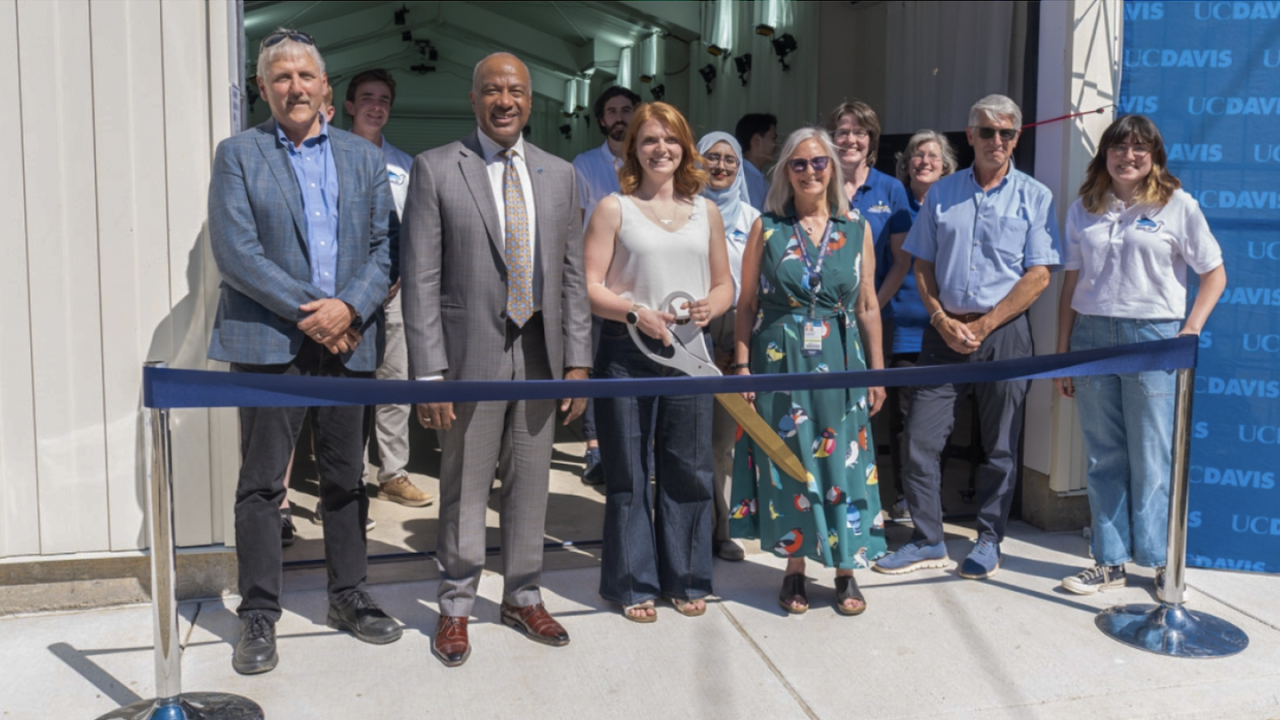 Chancellor May smiles while surrounded by campus leaders at the  grand opening of the Center for Animal Locomotion and Innovation. 