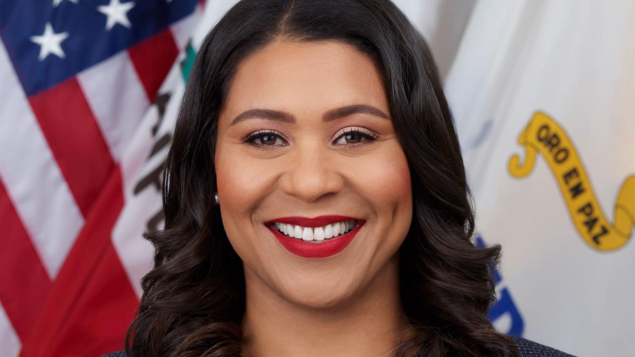 Mayor London Breed in front of American flag