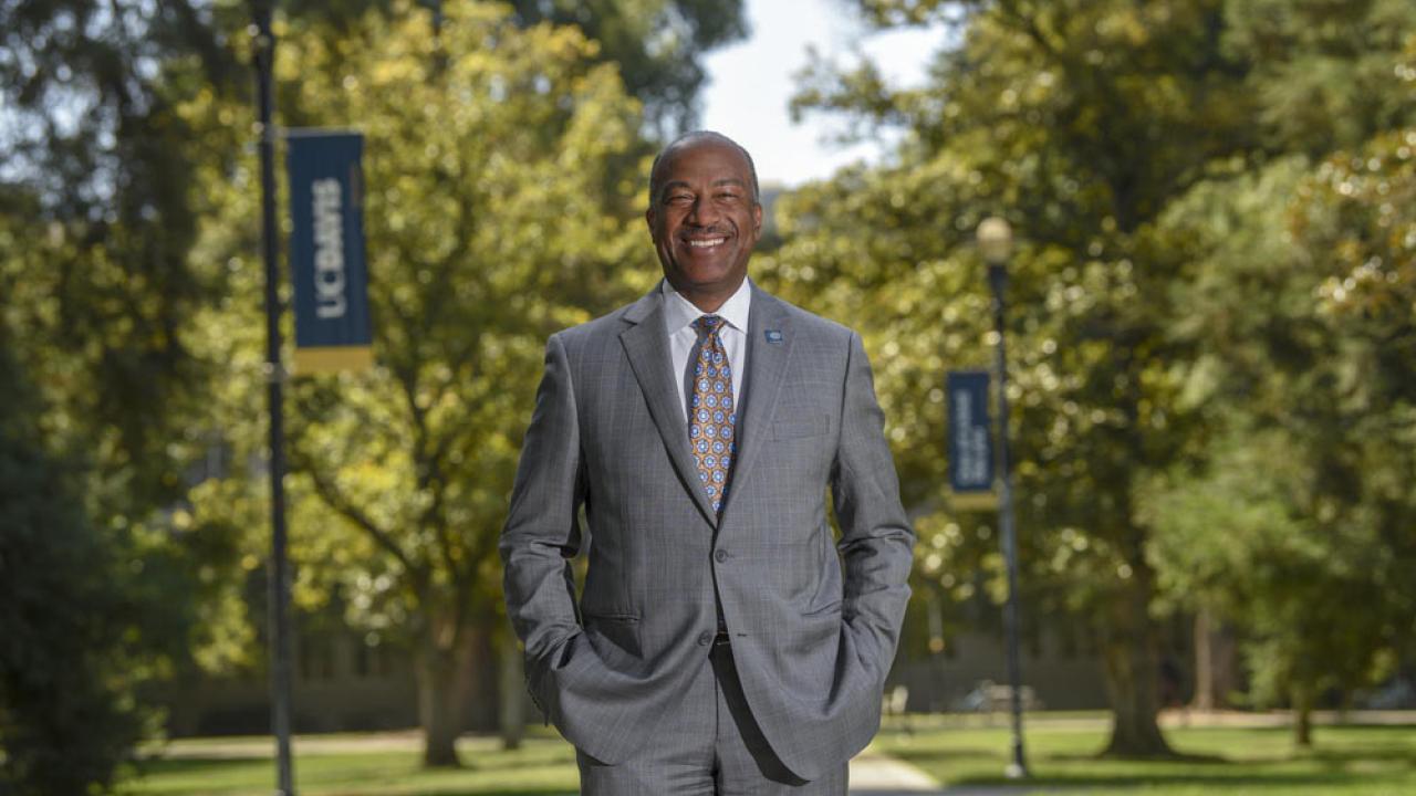 Chancellor Gary S. May, in a suit, on the Quad, portrait