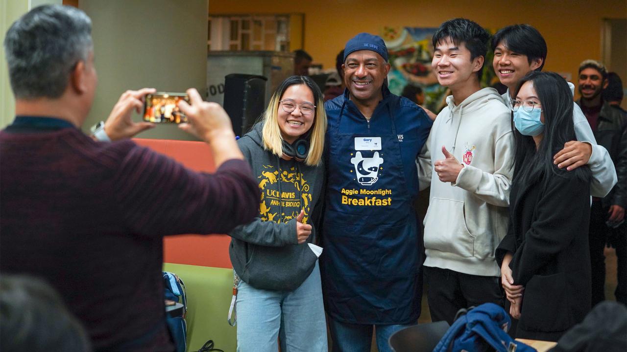 Chancellor may and students taking a photo at Moonlight Breakfast