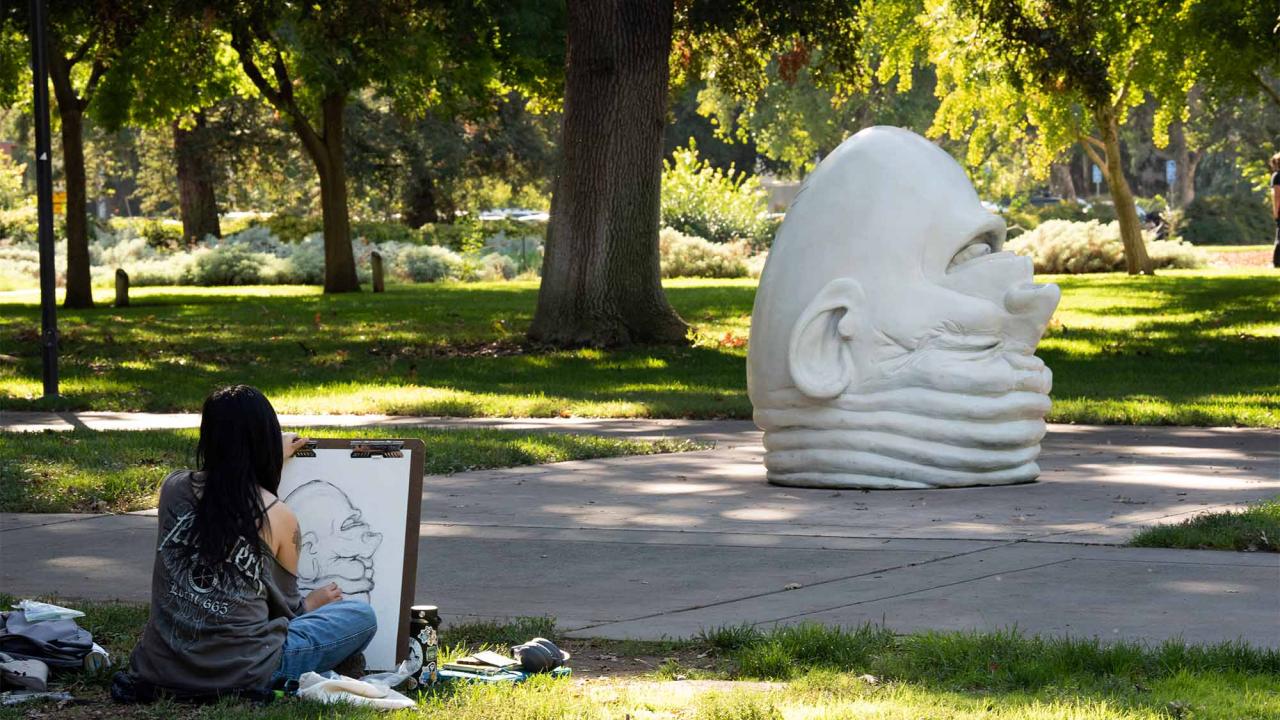 Student sketches Eye on Mrak Hall, an Egghead sculpture located outside of Mrak Hall on UC Davis' main campus.