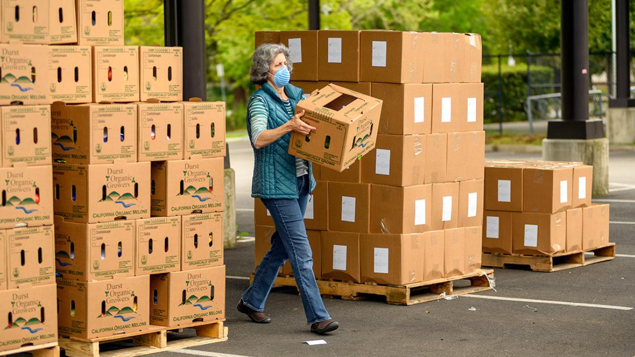 Woman loads box of food