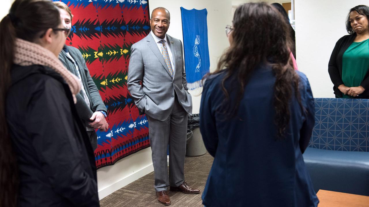 Chancellor May smiling, surrounded by a crowd.