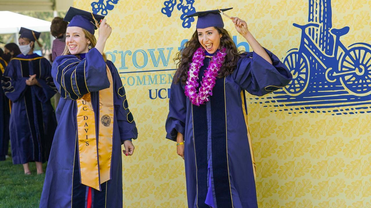 Graduates in their caps and gowns smiling