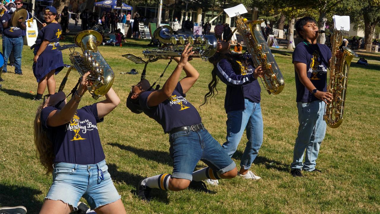 4 UC Davis band members playing saxophones.