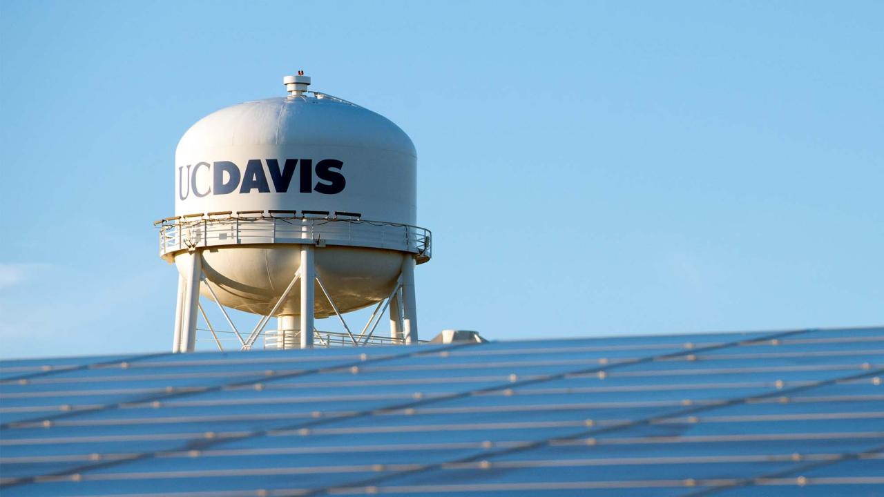 UC Davis water tower with solar panels in the foreground.