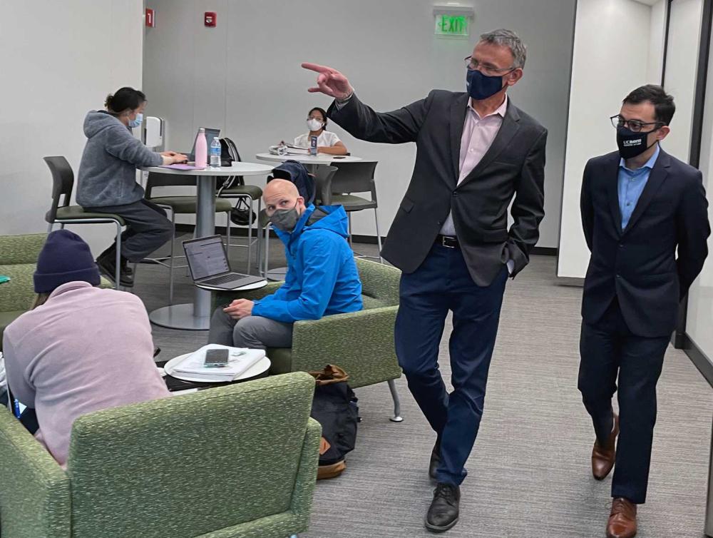 Two people walk through a study area