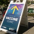 COVID-19 Vaccination Clinic a-frame sign with yellow arrow in front of ARC