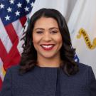 Mayor London Breed in front of American flag
