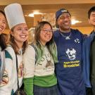 Chancellor Gary S. May poses for photo with students at Moonlight Breakfast event