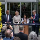 Diane Bryant cuts the ribbon to open the Engineering Student Design Center that bears her name as Chancellor Gary S. May, mechanical engineering major Tichada Tantasirikorn and Dean Richard Corsi look on. 