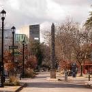 Image of a pedestrian street with two students walking on the left, bikes on the right