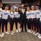 UC Davis Chancellor Gary May, wearing a suit and patterned tie, poses with the MK Modern Dance group before the start of their performance at the Fall Welcome event.